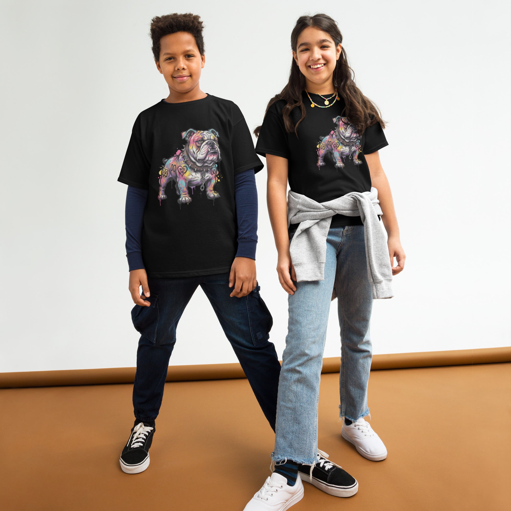 Two children wearing black t-shirts with cartoon character designs on a white background.
