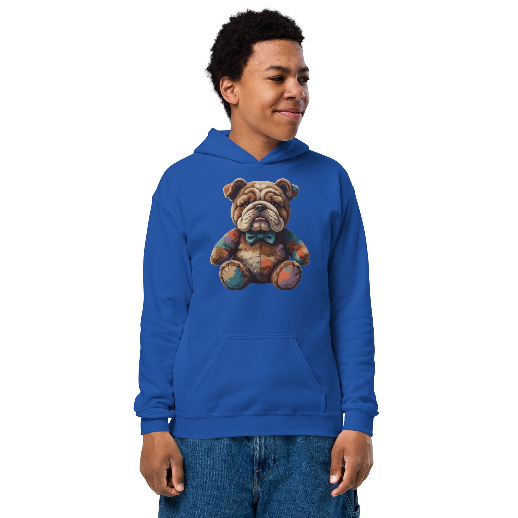 A young man wearing a royal blue hoodie with a colorful graphic of a teddy bear wearing a bow tie, paired with blue jeans, set against a plain white background.